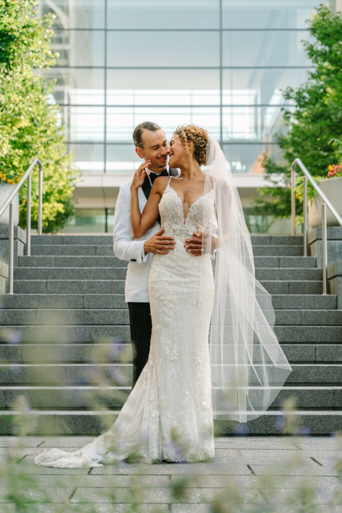 couple kissing by stairs