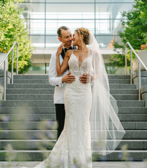 couple kissing by stairs