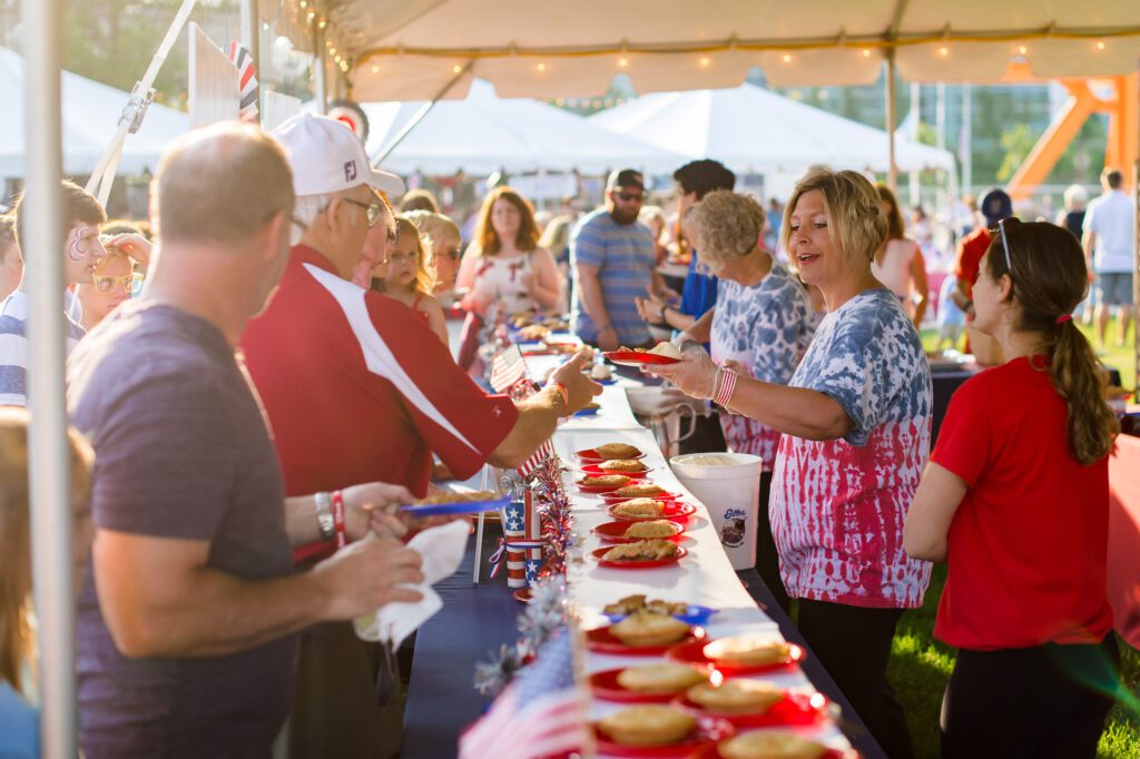 staff handing food to attendees