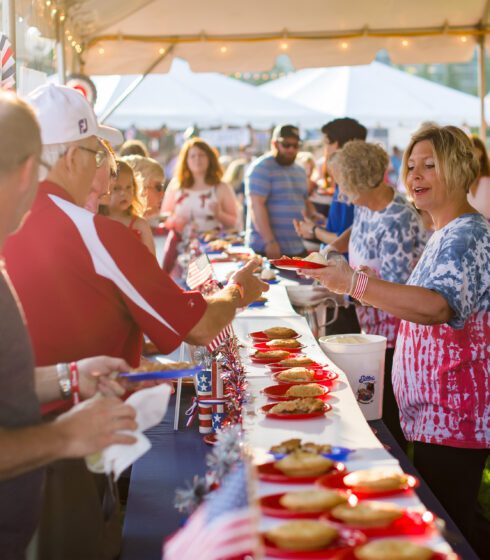 staff handing food to attendees