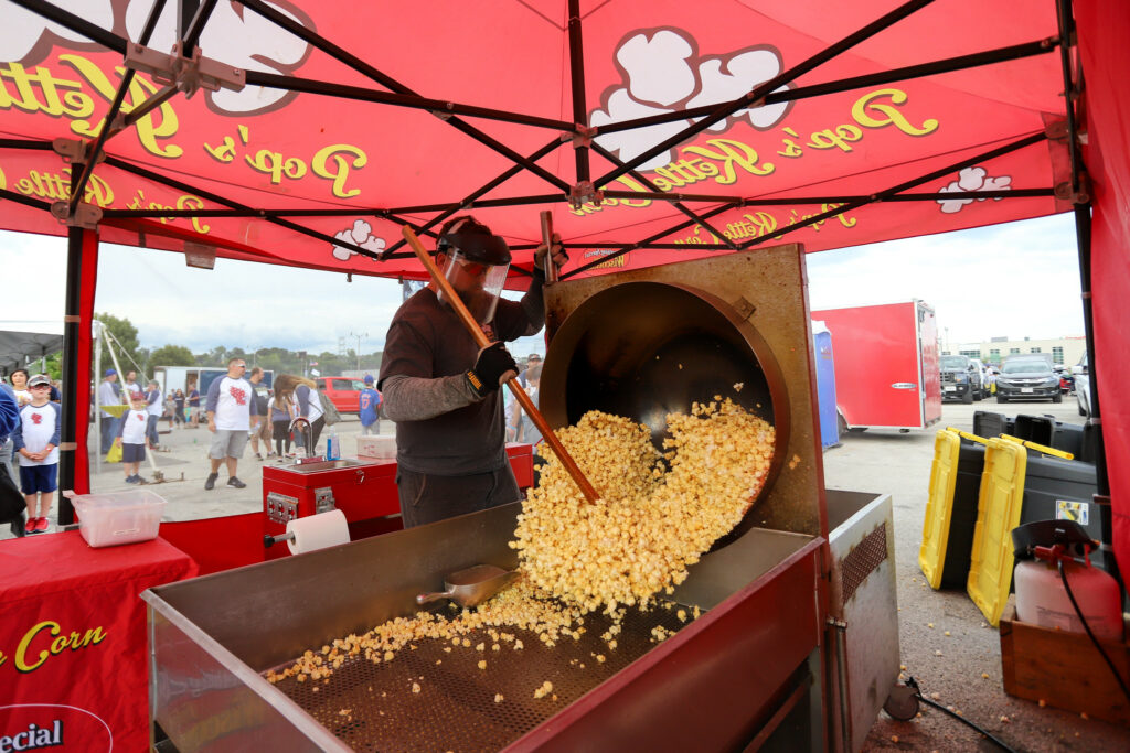 Person making popcorn at tailgate