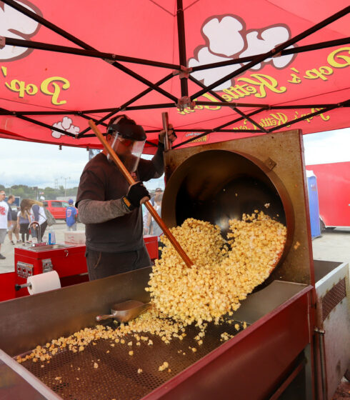 Person making popcorn at tailgate