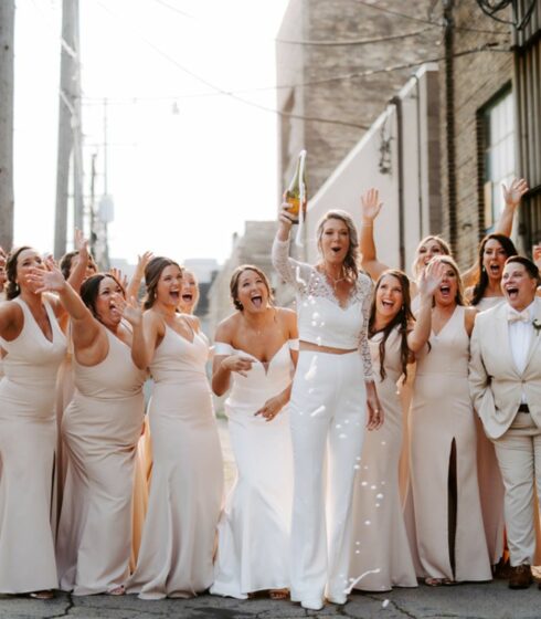 wedding party popping champagne bottle