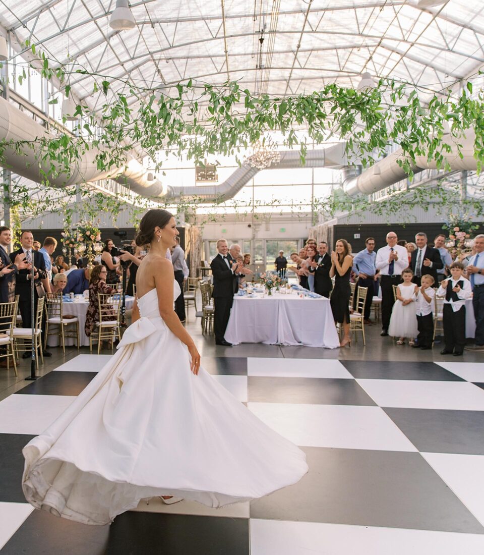 Bride in white dress under glass dome