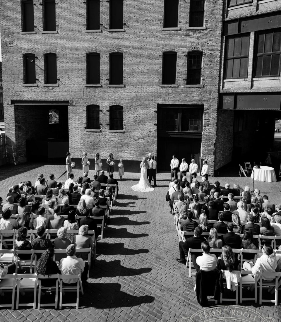 Outdoor wedding ceremony at brick building