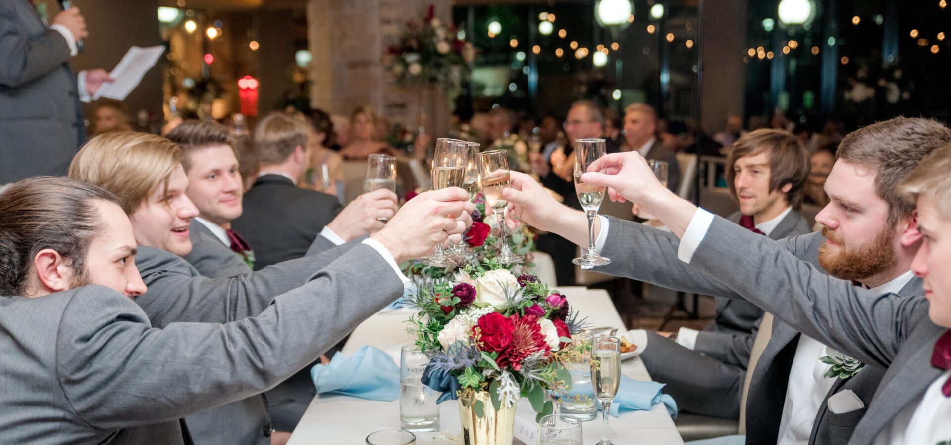 Groomsman cheers at wedding