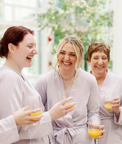 Happy bridesmaids in pink robes