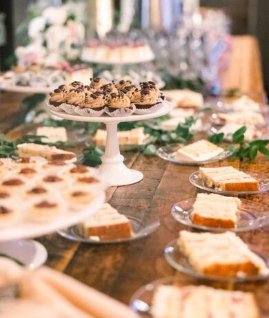 Beautiful dessert display on wood table featuring mini cupcakes