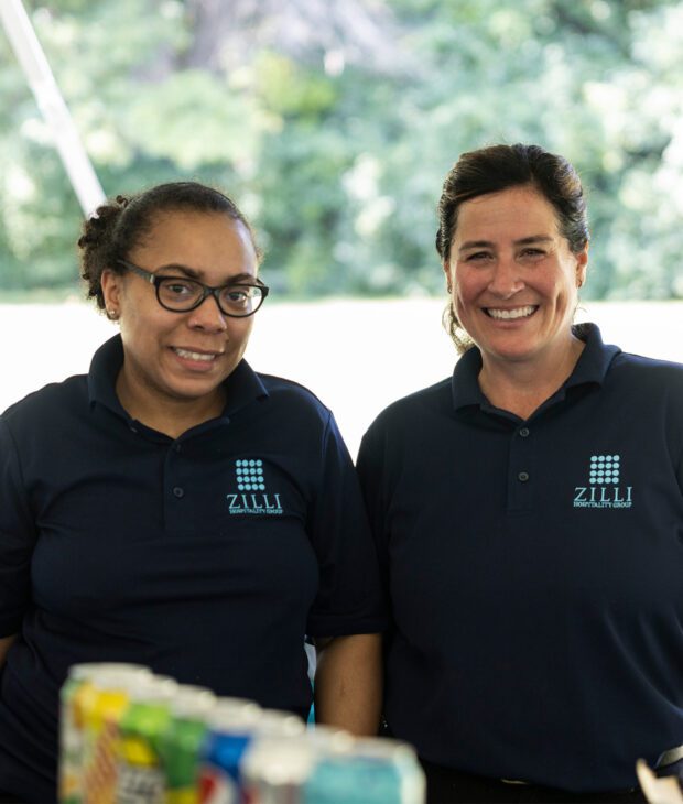 Two women in Zilli uniforms