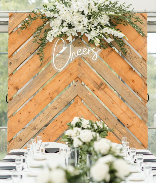 White wedding table setting with wooden sign and "Bride" in lights