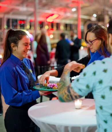 Woman serving appetizers milwaukee corporate event catering