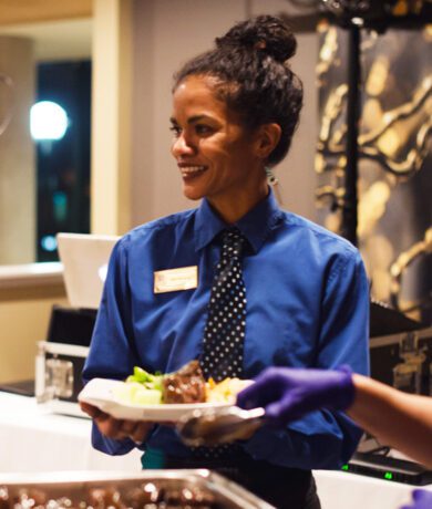 Smiling server with plate of food