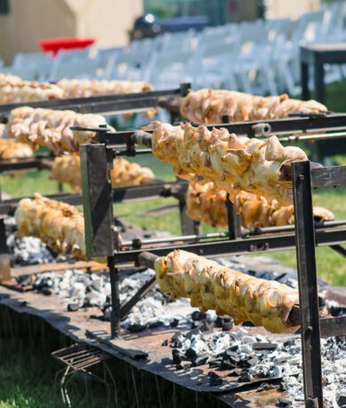 Chickens roasting over coals